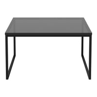 Black metal frame table with a sleek, matte finish and a clear glass top, ideal for modern decor.