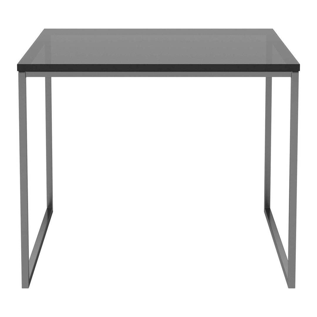 Modern gray square table with sleek metal legs, perfect for contemporary decor. Minimalist design with a smooth finish.