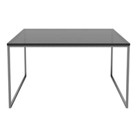 Sleek modern table with a gray glass top and minimalist silver steel legs, perfect for contemporary decor.