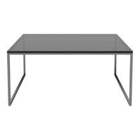 Sleek rectangular table with a smoky glass surface and minimalist metallic frame in silver. Modern and elegant design.