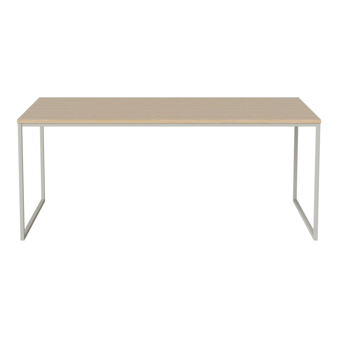 Minimalist beige table with a smooth surface and sleek silver metal legs, perfect for modern decor.