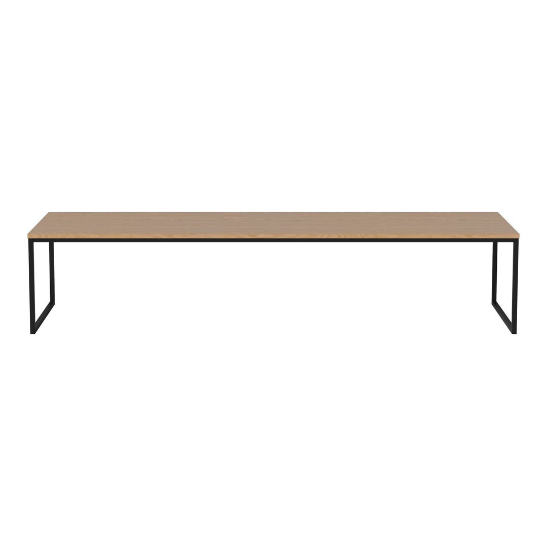 Long wooden tabletop in a natural finish with minimalist black metal legs, creating a sleek and modern look.