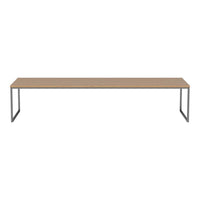 Long rectangular table with a light wood finish and sleek metallic gray legs, offering a modern minimalist design.