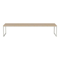 Long beige tabletop with a sleek white metal frame, offering a modern, minimalist design. Ideal for any space.