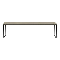 Long beige table with a smooth surface, featuring minimalistic black metal legs, creating a modern contrast.