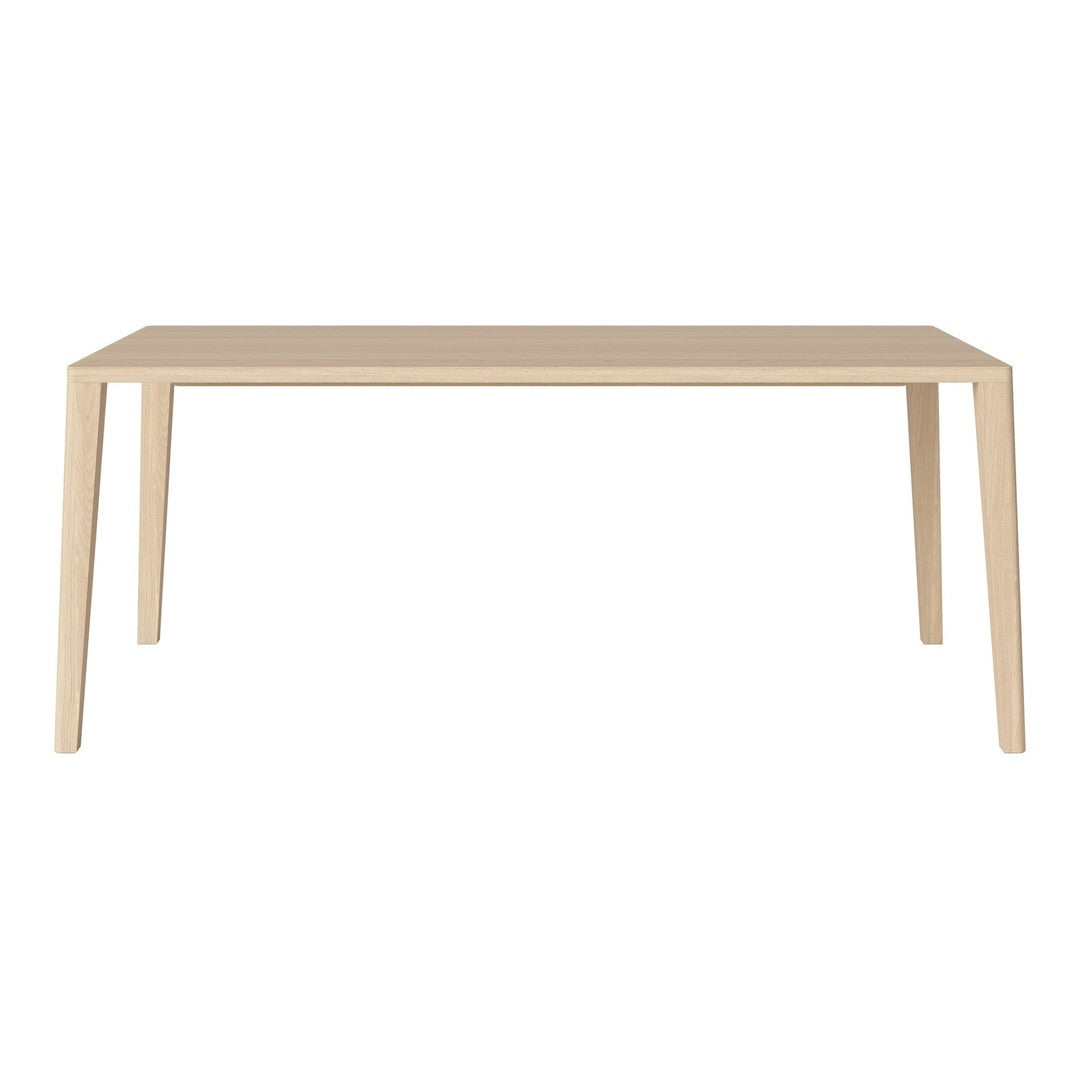 Light beige rectangular dining table with a smooth, minimalist design and straight legs. No patterns.
