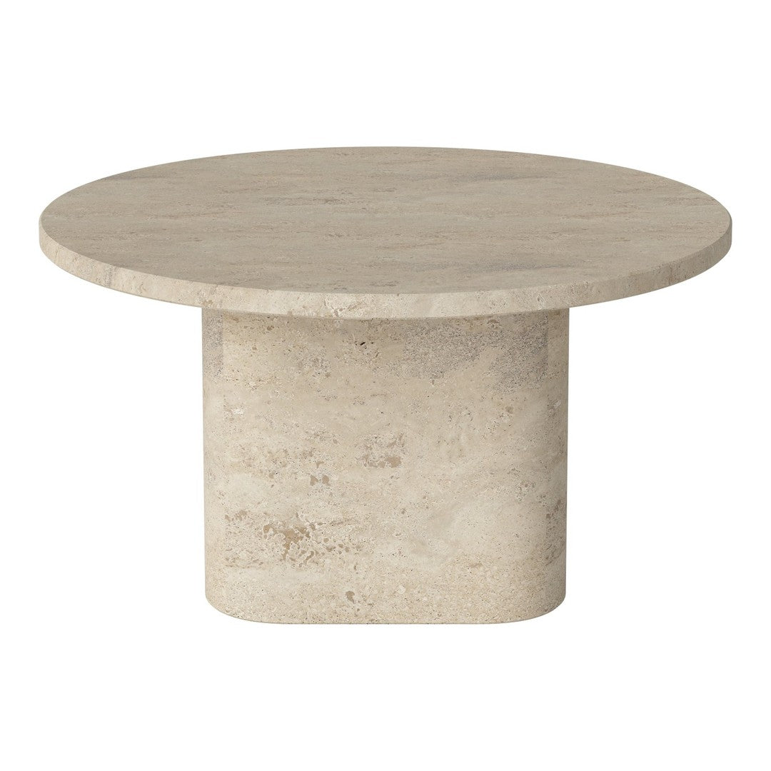 Round beige coffee table with a smooth top and textured base; minimalist design and neutral tones.