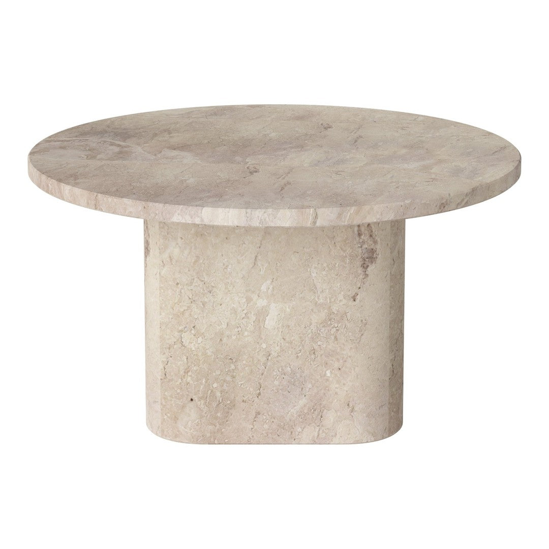 Round beige marble table with a smooth surface and subtle texture, featuring a minimalist design.