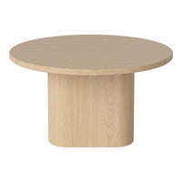 Light wood round coffee table with a smooth surface and a minimalist cylindrical base. Modern and neutral design.