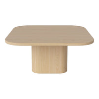 Light wooden square table with rounded edges and a simple, modern design. Neutral tones and smooth texture.