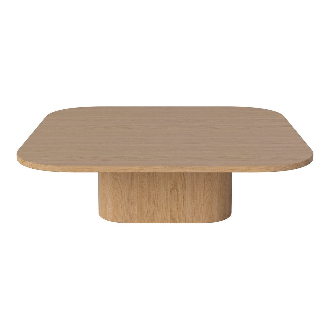 Natural light wood coffee table with a smooth, rounded square top and a cylindrical pedestal base.