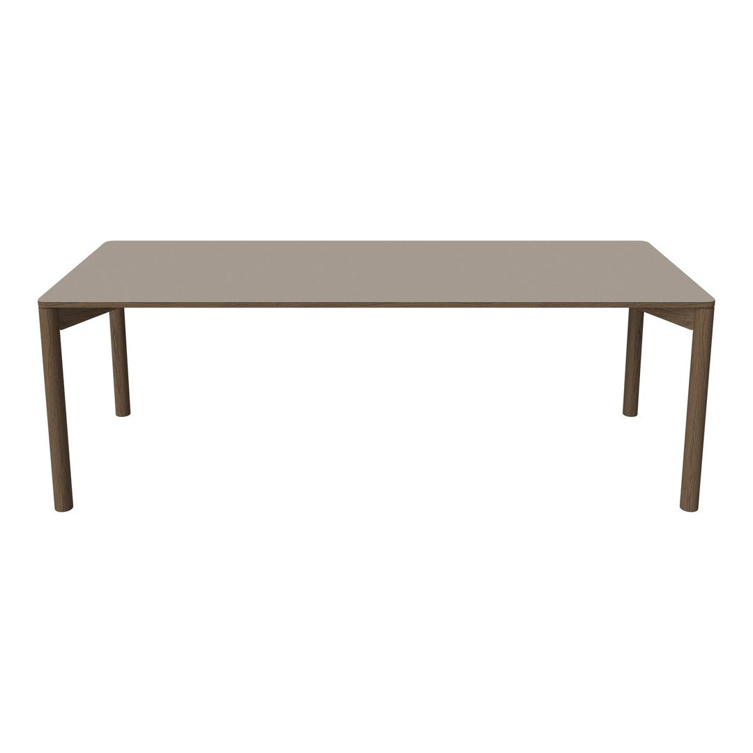 "Simple rectangular dining table in a sleek taupe finish with smooth, solid surface and clean lines."