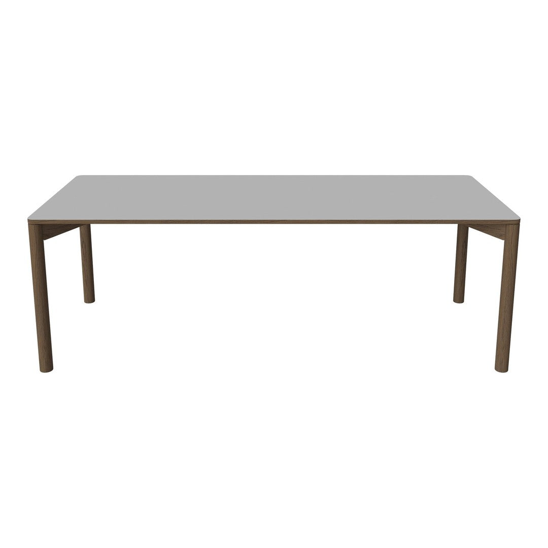Gray rectangular dining table with sleek, clean lines and wooden legs for a modern aesthetic.