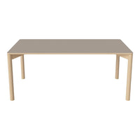 Light wood dining table with a smooth, taupe-colored top and minimalistic design. Perfect for modern interiors.
