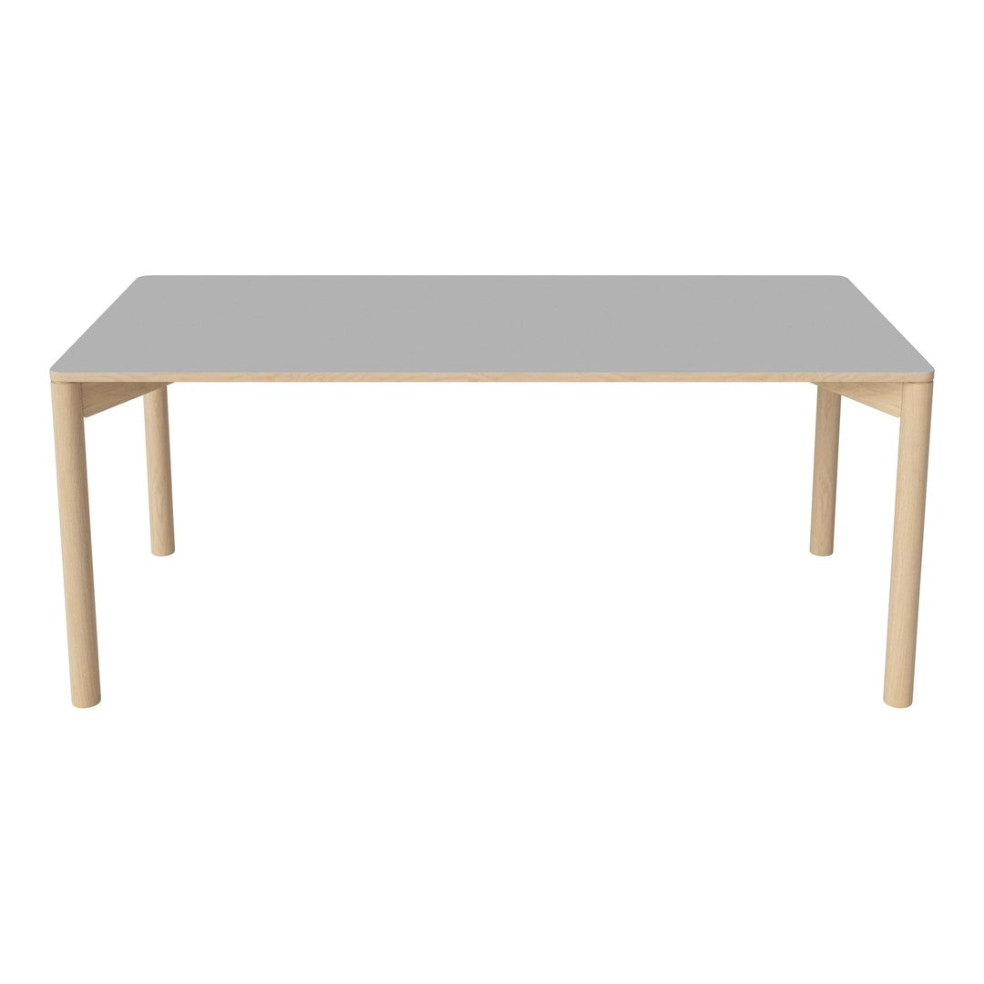 Light wooden table with a smooth gray top, featuring a minimalist design and clean lines. Ideal for modern decor.
