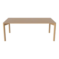 Light beige rectangular dining table with sleek, smooth surface and simple design, perfect for modern spaces.