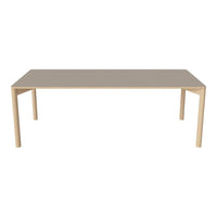 Light beige rectangular table with natural wood legs, featuring a smooth, minimalistic surface design.