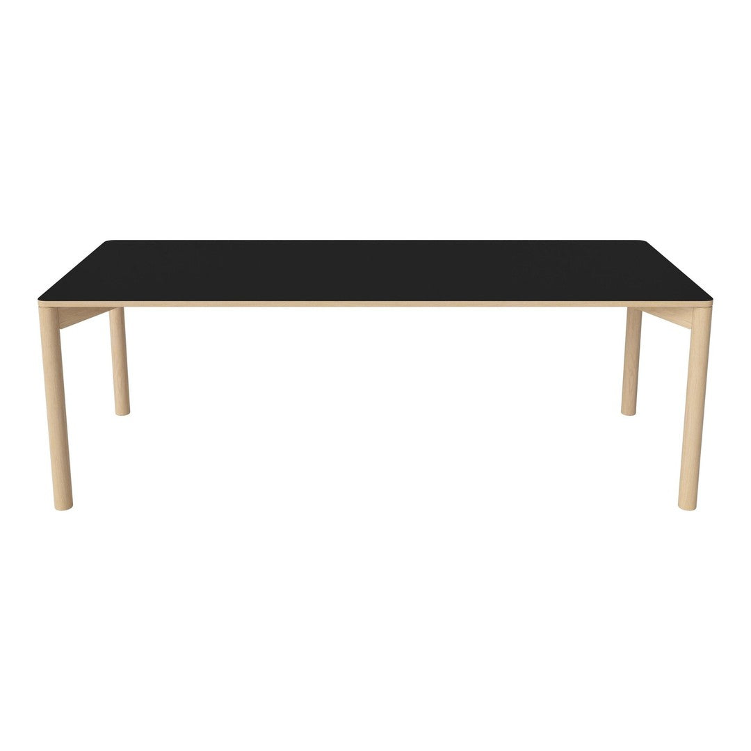 Black rectangular tabletop with a sleek finish and light wooden legs, perfect for modern dining spaces.