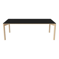 Black rectangular tabletop with a sleek finish and light wooden legs, perfect for modern dining spaces.