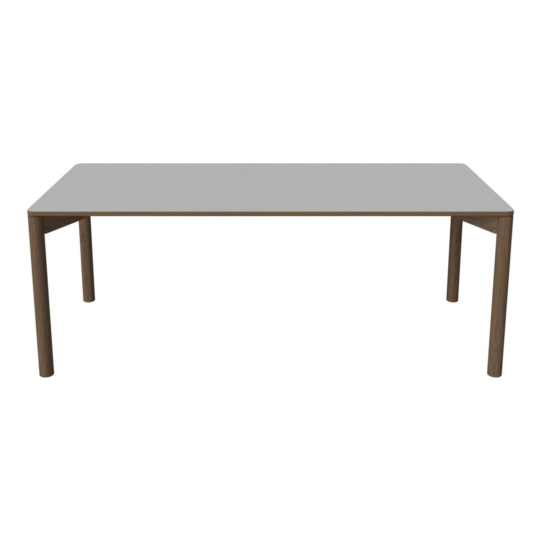 Grey rectangular dining table with a sleek, minimalist design and sturdy brown legs, perfect for modern interiors.
