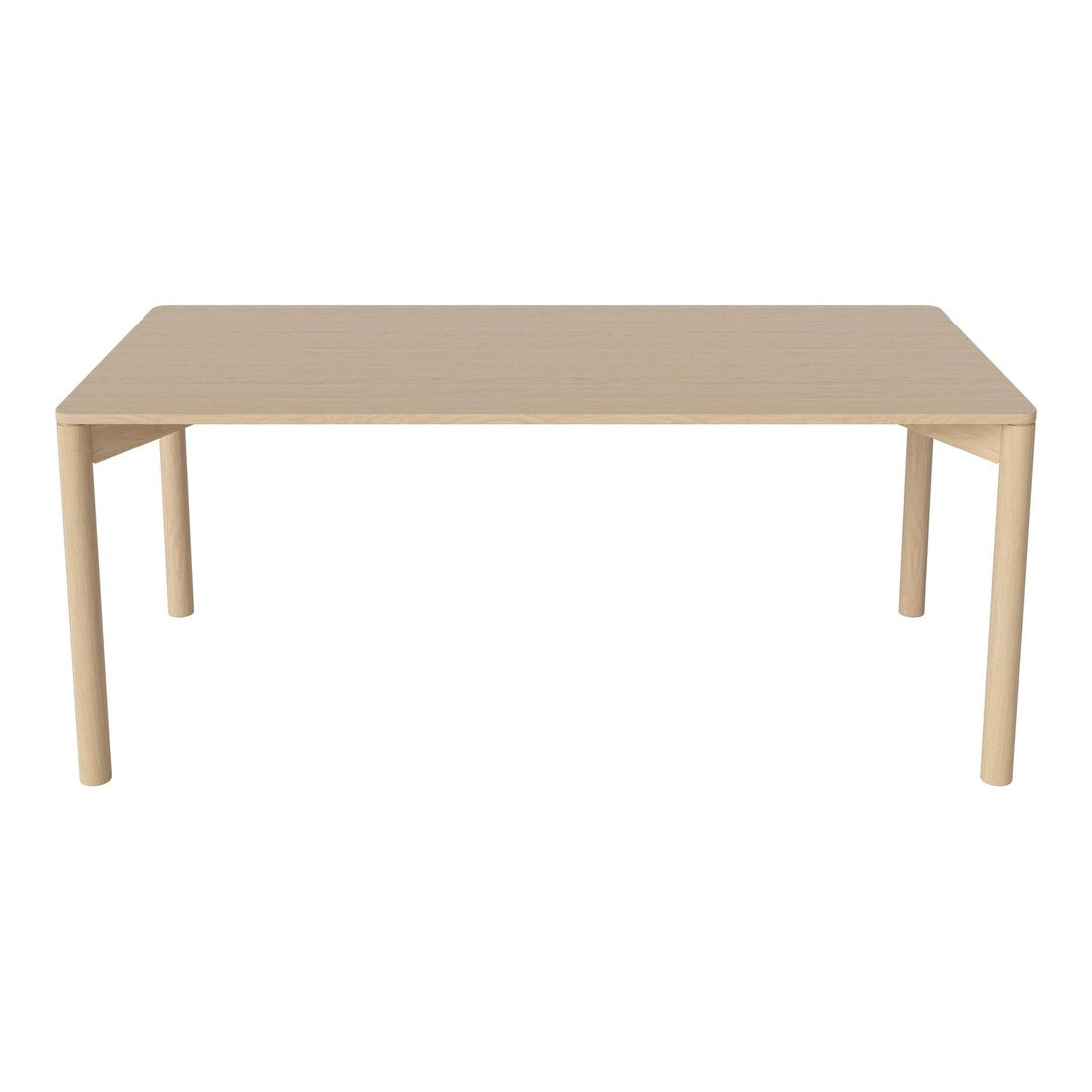 Beige rectangular table with a smooth surface and minimalist design, featuring four straight legs.