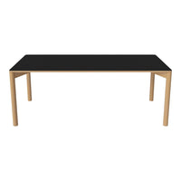 Sleek black tabletop with light wood legs, minimalist design, and modern aesthetic for contemporary dining spaces.