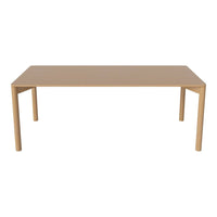 Beige rectangular table with a smooth surface and simple design, featuring solid, straight legs. Ideal for modern decor.