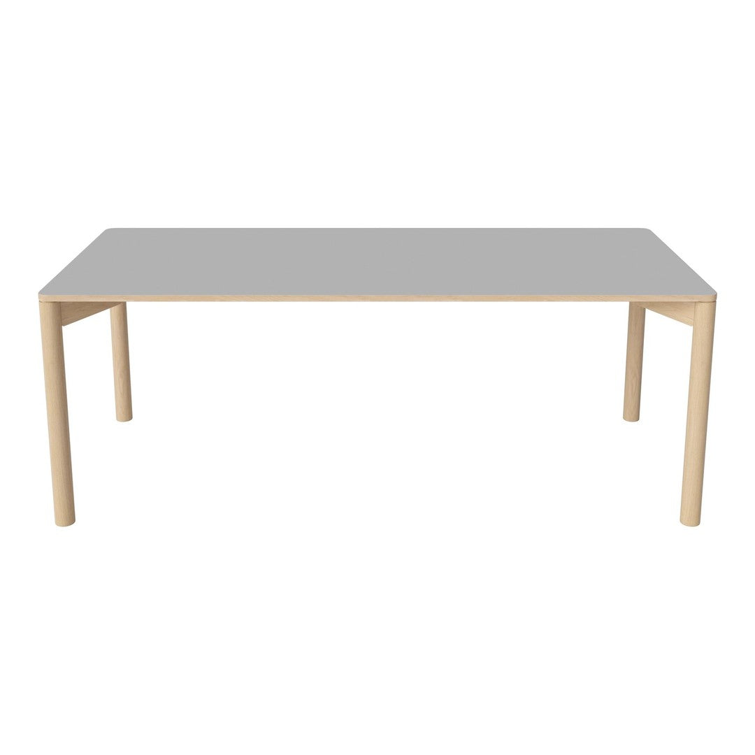 Gray rectangular table with light wooden legs, featuring a sleek, minimalist design and smooth surface.
