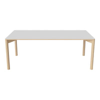 White tabletop with natural wood legs, featuring a sleek, modern design and minimalistic aesthetic.