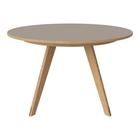 Round coffee table with a sleek gray surface and natural wood tapered legs, featuring a minimalist design.