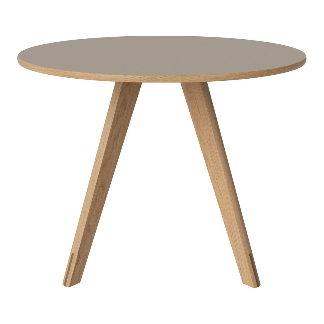 Round table with a soft gray surface and natural wood legs, featuring a minimalist design. Perfect for modern decor.