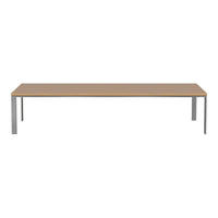 Modern rectangular table with a light wood finish and sleek silver metal legs, showcasing a minimalist design.