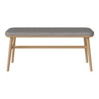 Gray upholstered bench with natural wood legs, featuring a sleek, minimalist design and subtle texture.