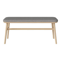 Gray upholstered bench with a light wood frame and minimalist design. Ideal for modern home decor.