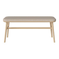 Light beige upholstered coffee table with natural wood legs and a simple, modern design. Ideal for contemporary decor.
