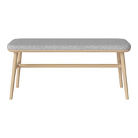 Gray upholstered bench with natural wooden legs, featuring a simple, modern design. Ideal for any decor style.
