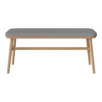 Gray upholstered bench with a natural wood frame, showcasing a minimalist design and smooth lines.