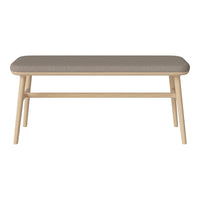 Light wood coffee table with a soft gray upholstered top, featuring a minimalist design. Perfect for modern decor.