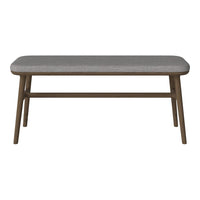 Gray upholstered bench with a textured pattern and brown wooden legs, perfect for modern decor.