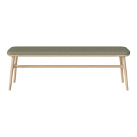 Green upholstered bench with a minimalist design and light wood legs, showcasing a modern and stylish aesthetic.