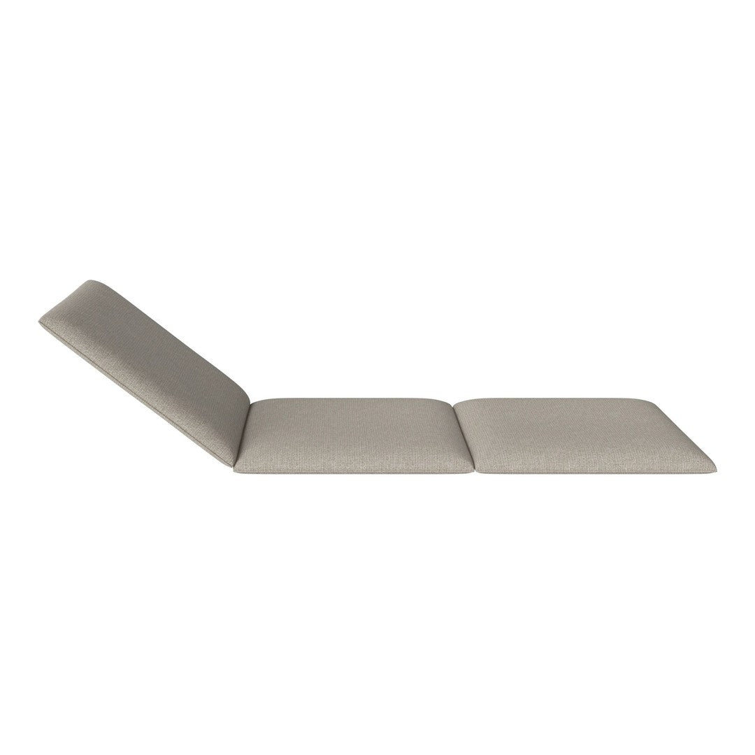 Light beige lounging chair with a sleek, minimalist design and subtle textured fabric. Perfect for modern spaces.