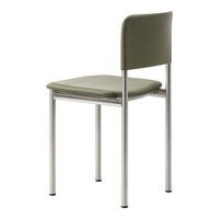 Green chair with a smooth, matte finish and sleek, silver metal legs. Minimalist design for modern decor.