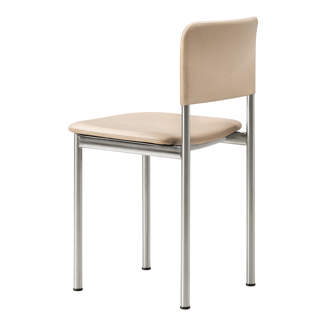 Beige upholstered chair with sleek silver legs, featuring a minimalist and modern design. Ideal for any decor.