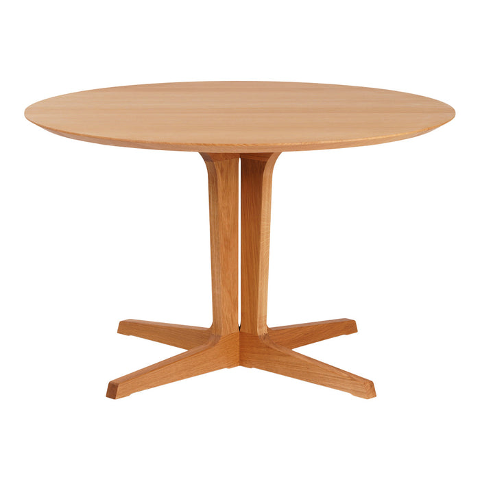 Round wooden dining table in a natural oak finish, featuring a sleek, minimal design with a smooth surface and simple base.