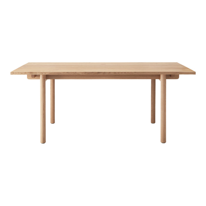 Natural wood dining table with a smooth, light beige finish and minimalist design. Ideal for modern decor.