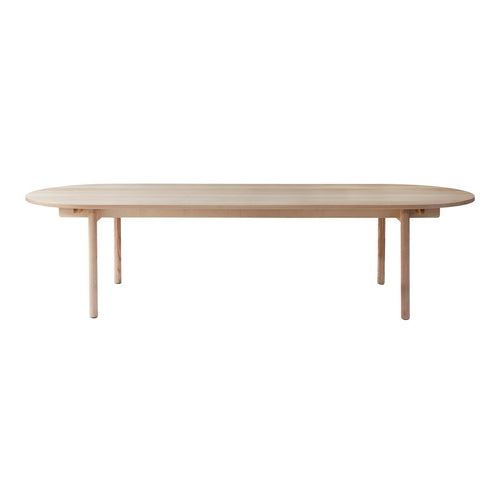 Light oak oval dining table with a smooth, minimalist design and natural wood grain pattern. Perfect for modern interiors.