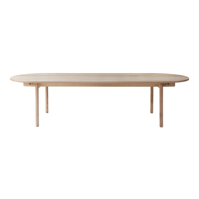 Light oak oval dining table with a smooth, minimalist design and natural wood grain pattern. Perfect for modern interiors.