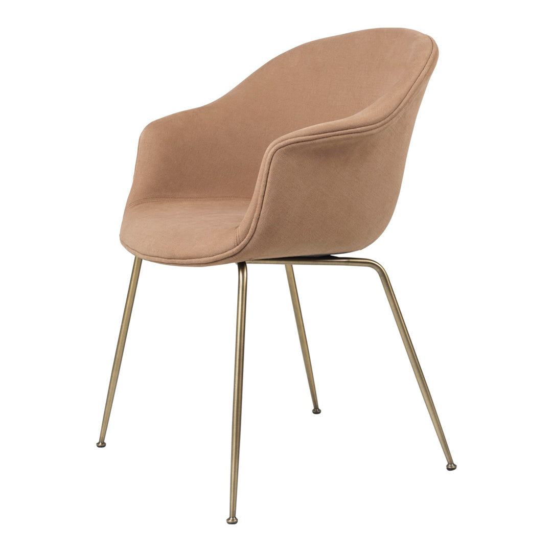 Beige upholstered chair with smooth curves and sleek metal legs, perfect for modern decor.