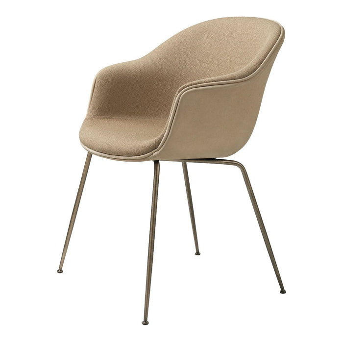 Tan upholstered chair with smooth curves and sleek metal legs, perfect for modern interior decor.