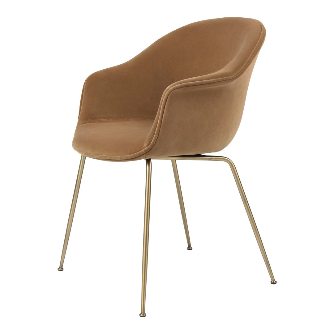 Tan velvet chair with a smooth finish and gold metal legs, showcasing a modern and elegant design.